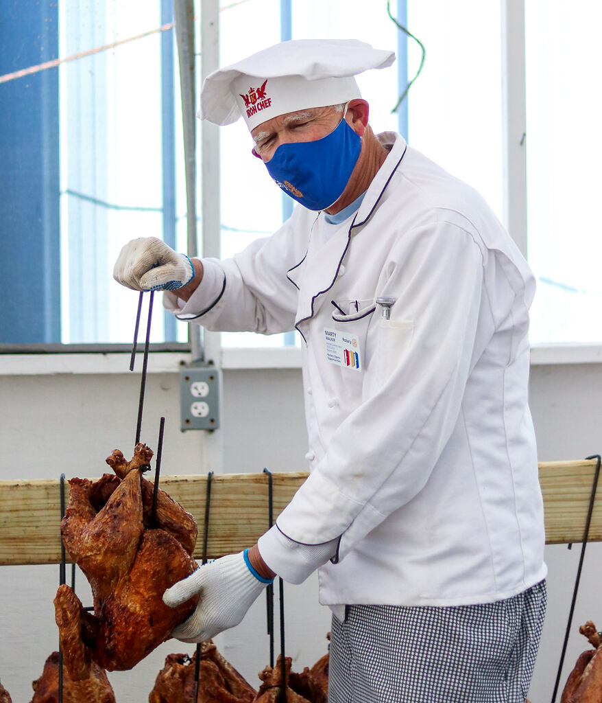 Marty Walkers holds up one of the turkeys he fried